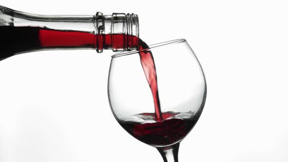 Rose Wine. Red Wine Pour in Wine Glass Over White Background