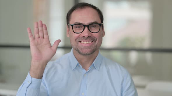 Middle Aged Man Waving Welcoming