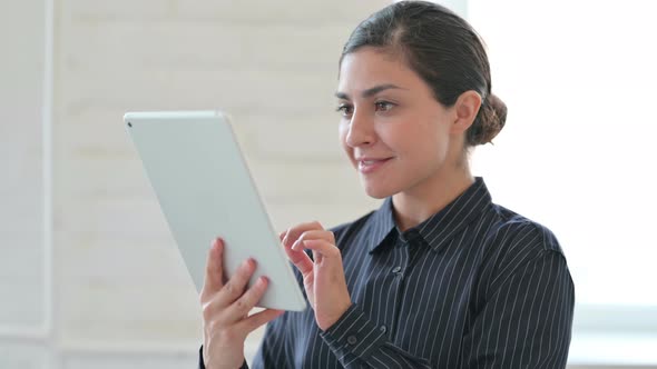 Excited Young Indian Woman Having Success on Tablet