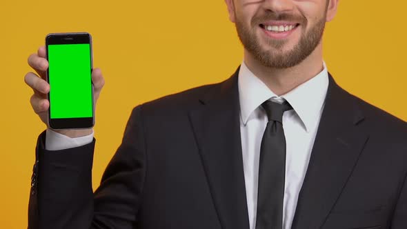 Satisfied With New Application Man Showing Thumbs-Up, Green Screen Smartphone