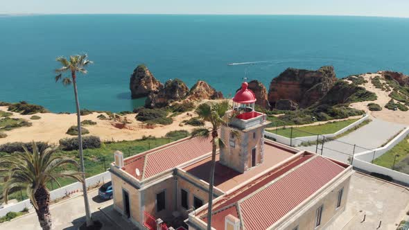 Close view of Ponta da Piedade Lighthouse over stunning headland in Lagos, Algarve, Portugal