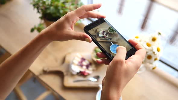 Closeup Of Female Hands Holding Smartphone Taking Photo Of Food.