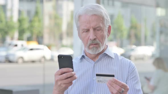 Excited Old Man Shopping Online Via Smartphone Outdoor