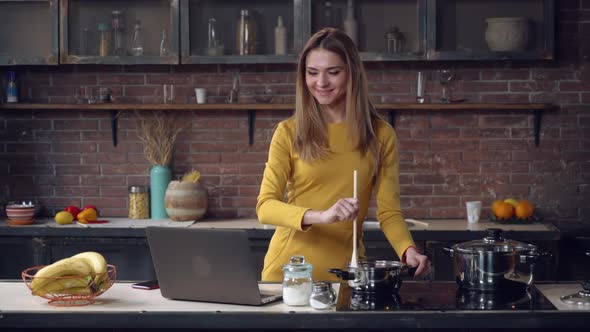 Caucasian Model Cooking Dinner Use Pc in Kitchen.