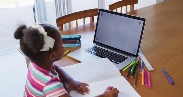 African american girl having online learning at home using laptop with copy space