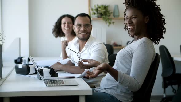 Joyful Colleagues Laughing During Work