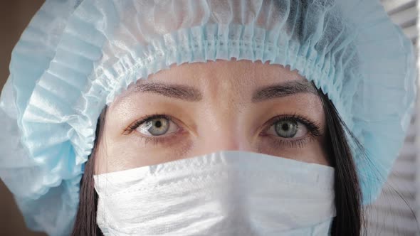 Tired Look of a Health Worker Wearing a Surgical Mask During a Break