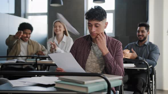 Sad Upset Abused Depressed Student Sits in Classroom at Desk Alone Suffers From Bullying Aggressive