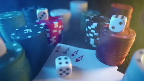 Casino Chips with Dice and Playing Cards on a Dark Table