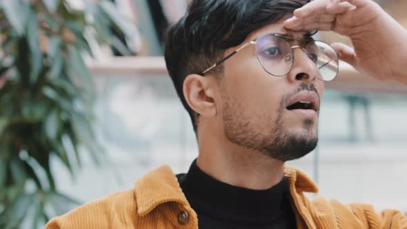 Closeup Young Indian Guy Waiting for Date Meeting Puzzled Man Worries Keeps Hand on Forehead Looking