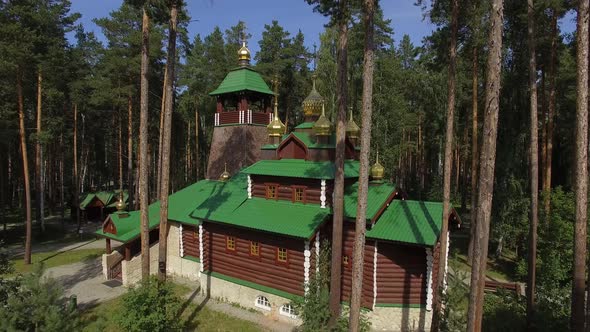 Aerial view of church in Monastery in forest. Sunny summer day