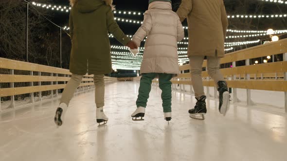 Family Ice-Skating Outdoors Together