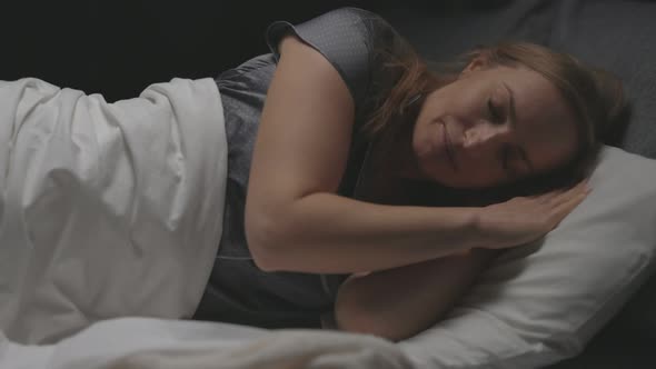 Woman Sleeping in Bed