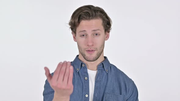 Young Man Pointing with Finger and Inviting on White Background