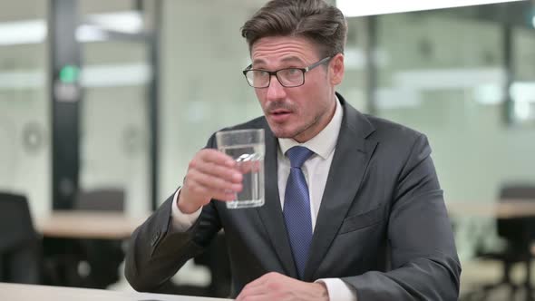 Thirsty Middle Aged Businessman Drinking Water