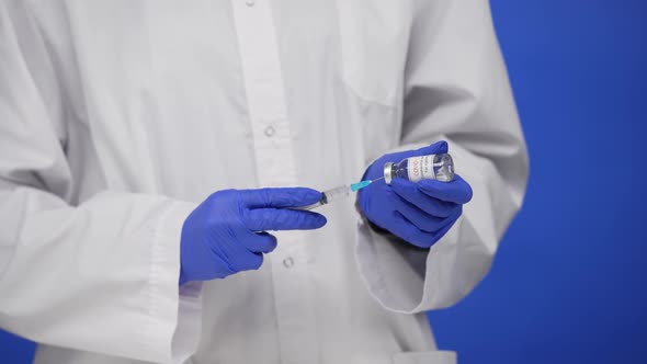 Male Doctor Holds Syringe and Bottle of Coronavirus COVID19 Vaccine Concept of Corona Virus