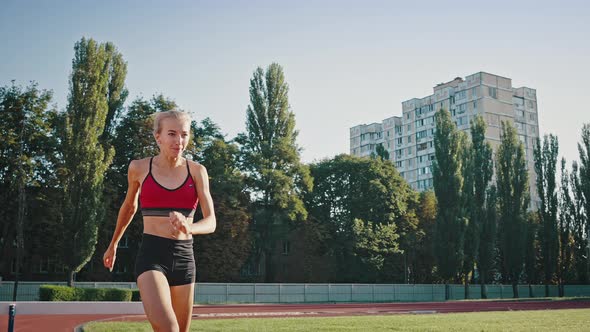 Closeup Sunny Portrait of a Professional Jogging Blonde Girl