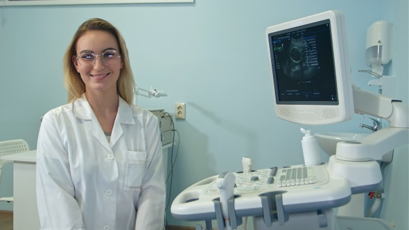 Smiling female doctor in glasses looking into the camera