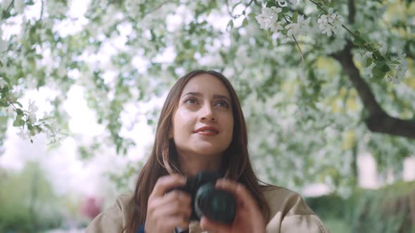 Young woman taking pictures with camera