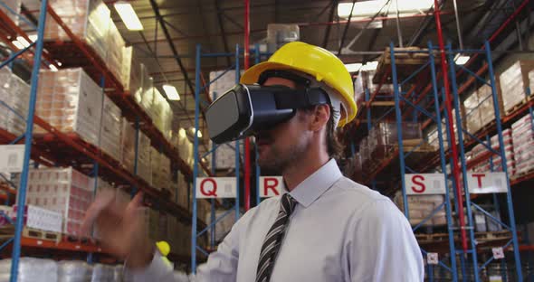 Male warehouse manager in VR goggles 4k