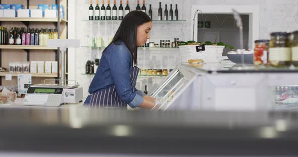 Animation of biracial waitress taking food from fridge