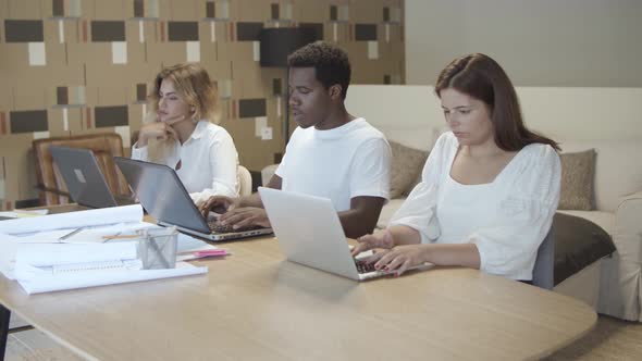 Team of Professionals Sitting Together at Table