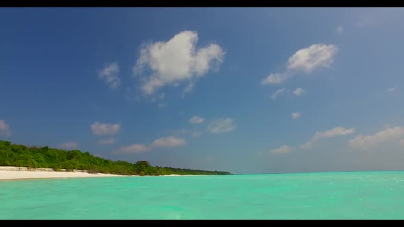 Aerial nature of idyllic tourist beach vacation by blue ocean with white sand background of a picnic