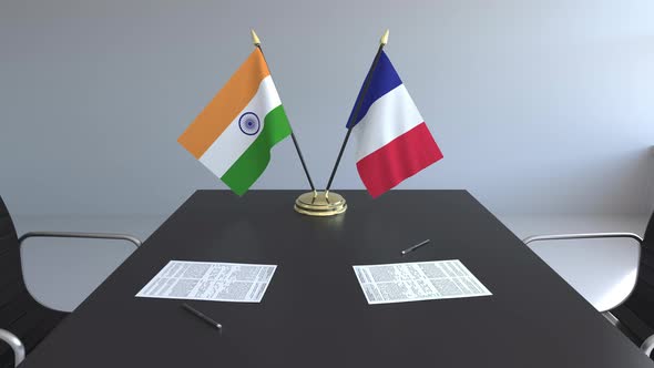 Flags of India and France and Papers on the Table alt