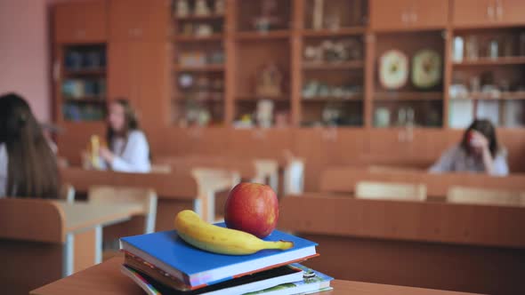 Fruits Lie on the Books During Class Break