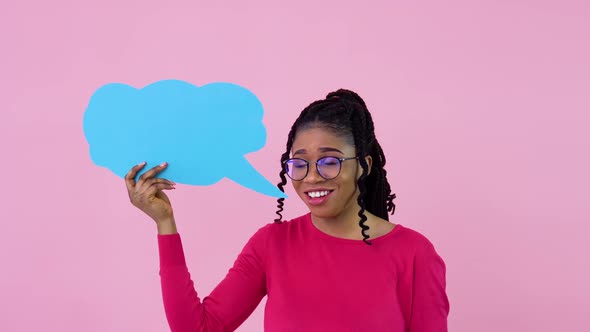 Cute Young African American Girl Stands with Posters for Expression on a Solid Pink Background