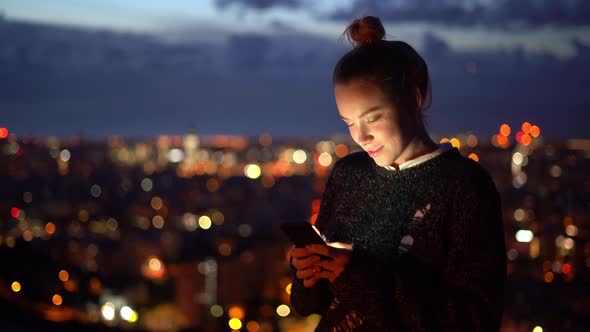 Woman with smartphone writing text message