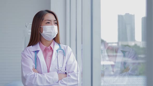 Asian female doctor wearing a white mask