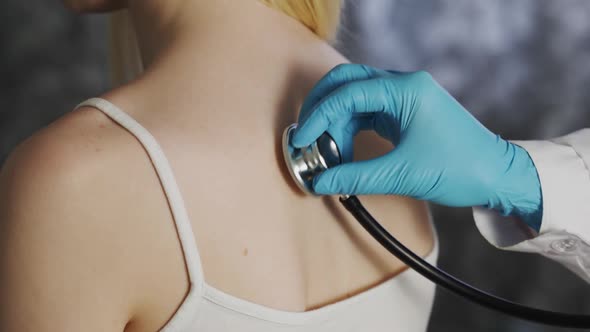 Female Doctor Using Her Stethoscope To Listening Her Female Patient's Lung While He Breath