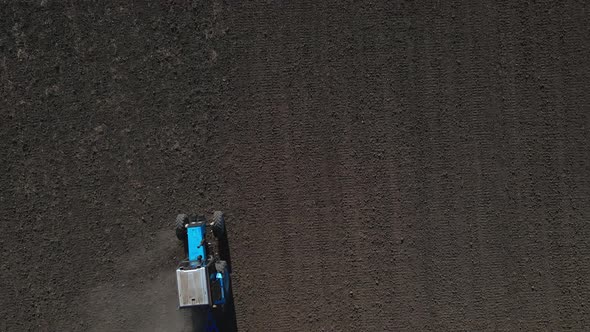 Aerial View of Agricultural Tractor Performing Fall Tillage in Stubble Field