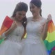 Asian Lesbian Couple With LGBT Flag Walking Together In The Park. - VideoHive Item for Sale