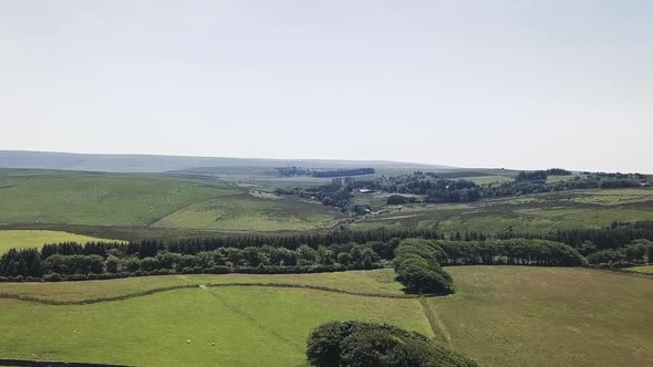 Aerial view of agricultural lands in Dartmoor National Park, England. Animals grazing in the distanc
