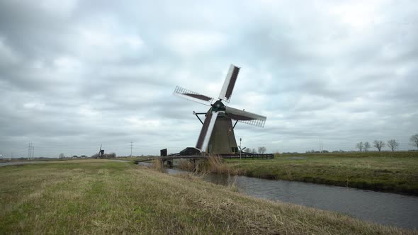 Dutch windmill in wetlands turning in strong winds, still shot