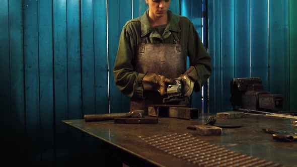 Female welder working at work shop