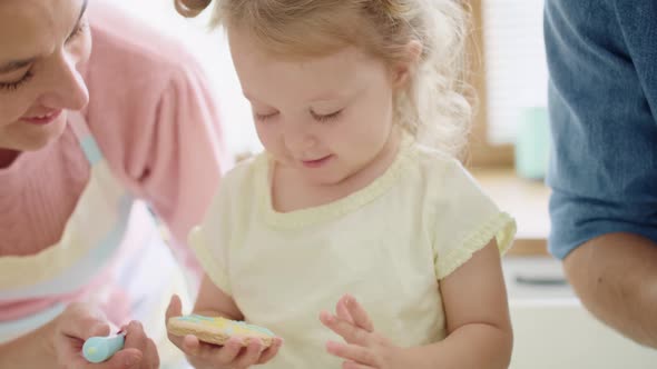 Handheld view of little girl making her first cookie. Shot with RED helium camera in 8K  