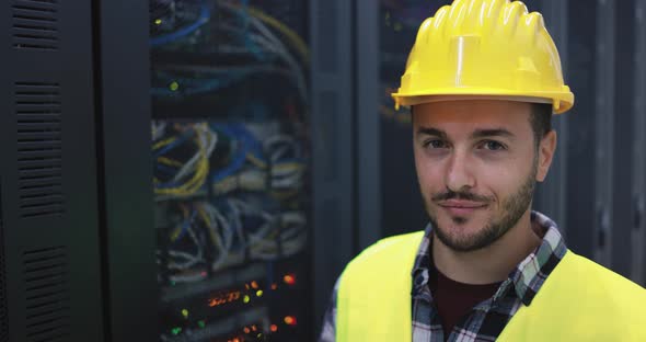 Technician man looking serious in camera inside server room