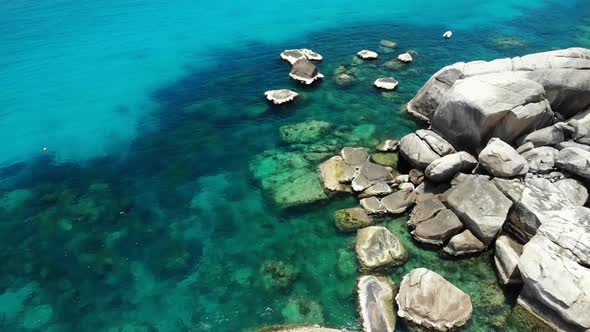 Calm Sea Water Near Stones. Peaceful Blue Sea Water and Gray Boulders in Perfect Place for