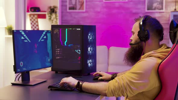 Hipster Man Playing Professional Video Games in His Room