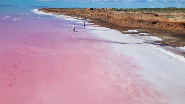 Drone View of Colorful Pink Lake with Wide White Salt Coast