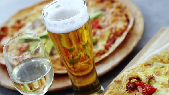 Delicious pizza with a glasses of beer and wine