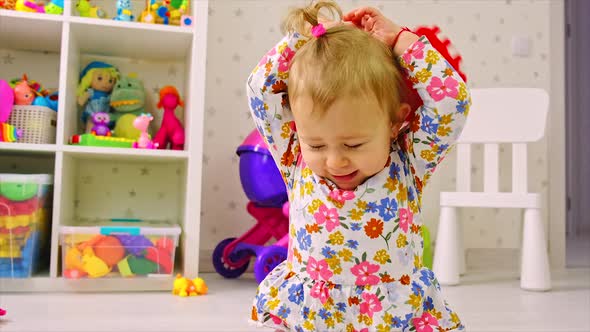 The Child Plays with Toys in the Room