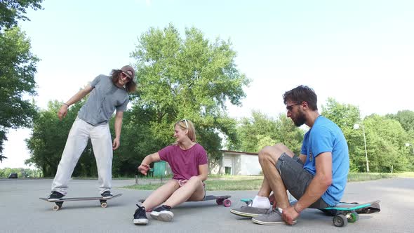 Cheerful young skateboarders chilling and doing tricks on skateboard