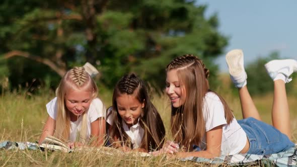 Three Little Friends Read a Book Together in Nature