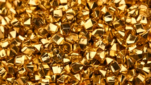 Abstract background of golden nuggets spinning