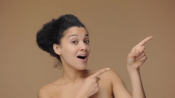 Beauty Portrait of Young African American Woman Pointing Side Hand for Something Nods and Shows