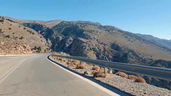 POV car riding on a coastal mountain national road